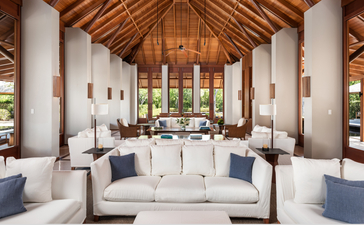 Five-bedroom beach villa sala at Amanyara with soaring wooden ceiling, white furnishings and ocean views.