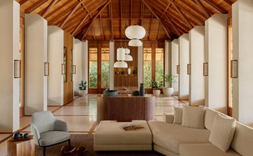 Four-bedroom Tranquility Villa living area at Amanyara, Turks and Caicos, with wooden vaulted ceiling and cream furnishings.