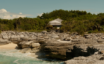 Ocean cove pavilion at Amanyara surrounded by rocky shoreline and tropical vegetation, Turks and Caicos.