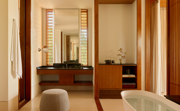Ocean Cove Pavilion dressing room at Amanyara with wooden cabinetry and mirror.