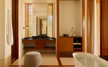 Ocean Pavilion bathroom with soaking tub and wooden vanity at Amanyara resort, Turks and Caicos.