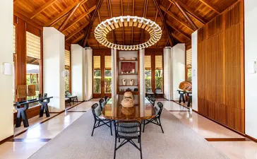 Six-bedroom villa living area at Amanyara resort, Turks and Caicos, with wooden architecture and central seating.