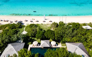 Six-bedroom villa with infinity pool overlooking turquoise waters and white sand beach at Amanyara resort, Turks and Caicos.
