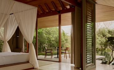 Tranquility Pavilion at Amanyara with draped bed opening to terrace and tropical gardens, Turks and Caicos.