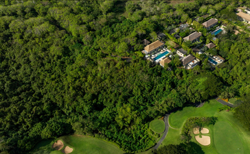 Aerial view of Aman Villas at Nusa Dua nestled amongst tropical forest and manicured grounds, Indonesia.