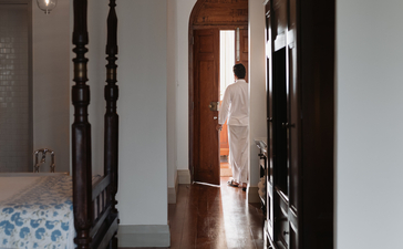 Colonial-style corridor with dark wooden doors at Amangalla, Sri Lanka.