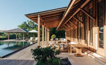 Four-bedroom beach sala villa with wooden architecture overlooking infinity pool at Amanyara, Turks and Caicos.