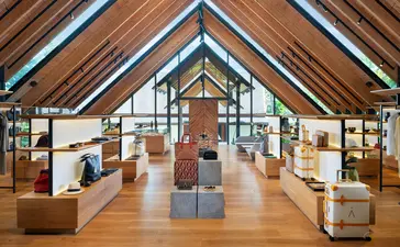 Boutique Aman Essentials au resort Amanpuri, avec étalages de produits sous un plafond en bois à poutres apparentes.