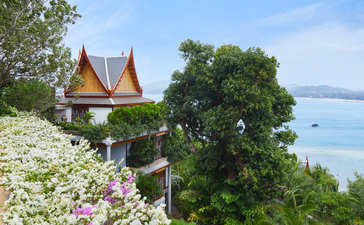 Eight-bedroom ocean villa terrace at Amanpuri overlooking the Andaman Sea, with traditional Thai architecture and lush gardens.