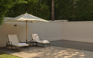 Shaded sun loungers beside the pool at Amantaka, Laos.