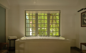 Double treatment room with jacuzzi overlooking gardens at Amantaka wellness spa, Laos.