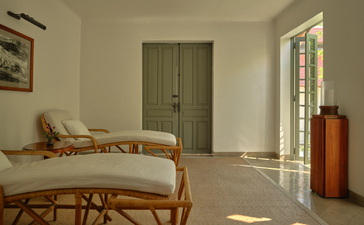 Amantaka wellness spa relaxation room with daybed, soft natural light, and serene minimalist interior.