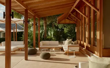 Villa outside living area with wooden pergola, seating and plunge pool at Amanyara resort, Turks and Caicos.