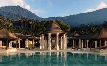 Amanjiwo's poolside pavilions and dining terrace with forested mountain backdrop at sunset.