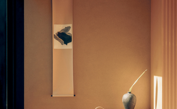 Minimalist interior suite at Aman Kyoto with warm timber tones, natural light, and simple furnishings.