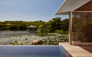 Amanoi resort wellness pool villa with views across the lake towards verdant Vietnamese landscape.