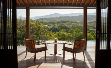 Mountain pool villa terrace at Amanoi with valley views and seated dining area.