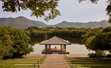 Yoga pavilion at Amanoi overlooking manicured lawns and forested mountains in Vietnam.