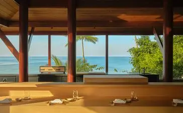 Nama omakase counter with wooden table setup overlooking the sea at Amanpuri, Thailand.