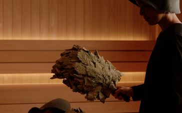 A therapist performs a traditional massage treatment on a guest at Aman Nai Lert Bangkok's spa house.