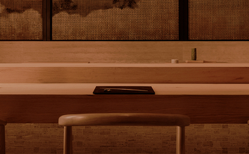 Wooden desk with chair and mirror at Aman Nai Lert Bangkok.