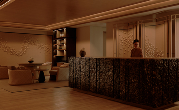 Aman Nai Lert Bangkok spa reception desk with warm wooden finishes and carved details.