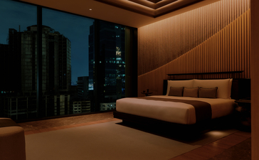 Aman Suite bedroom at Aman Nai Lert Bangkok with warm wooden panelling and contemporary furnishings.