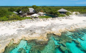 Aerial view of Amanyara's five-bedroom villa with white sand beach and turquoise waters, Turks and Caicos Islands.