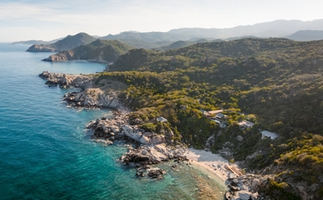 Aerial view of Amanoi's ocean pool residence overlooking Vietnam's rugged coastline and turquoise waters.