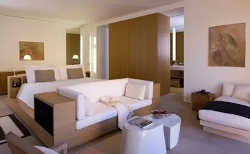 Principal bedroom at Amangiri with neutral tones, contemporary furnishings, and warm ambient lighting.