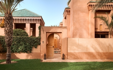 Entrance pavilion with terracotta walls and traditional Moroccan architecture at Amanjena resort.