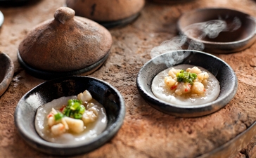 Afternoon tea service at Amanoi featuring bánh căn, Vietnamese savoury pancakes served on small plates.