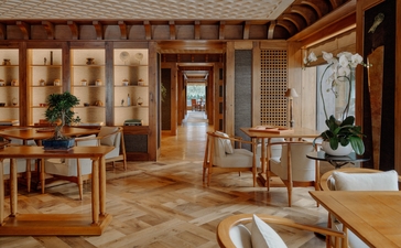 Wooden interior of a spa suite at Aman Le Mélézin, featuring natural light and minimalist furnishings.