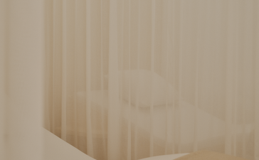 Spa and wellness area at Aman Le Mélézin with soft, draped fabrics and warm neutral tones.