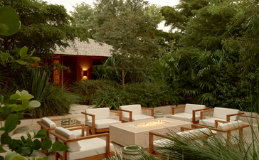 Fire pit seating area surrounded by lush vegetation at Amanyara resort, Turks and Caicos.