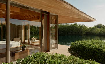 Pavilion villa with open-plan living area and expansive terrace overlooking gardens at Amanyara resort, Turks and Caicos.