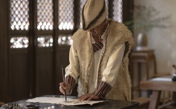 Master craftsperson demonstrates traditional Dongba handwriting technique at Amandayan, China.
