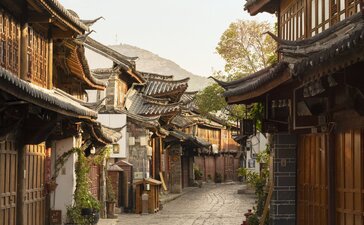 Stone-paved street lined with traditional wooden buildings in Lijiang Old Town, Amandayan.