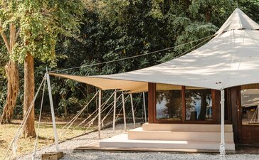 Canvas tent with wooden deck overlooking ocean at Amanwana, Indonesia.