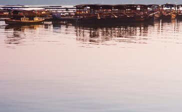 Wooden boats moored on still water at dawn, Amanfayun, Hangzhou.