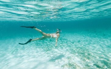 Snorkeller exploring turquoise waters at Amanyara resort, Turks and Caicos.