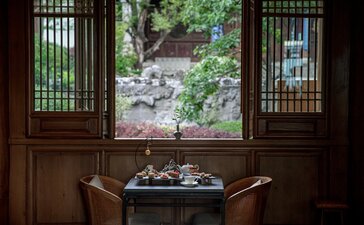 Tea house at Amandayan with view of garden stream through wooden screens.