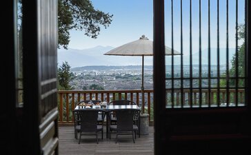 Tea house terrace at Amandayan with views across the landscape beyond wooden railings.