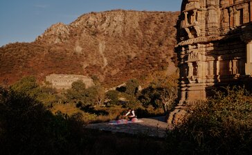 Yoga session at sunrise with Aravalli Hills backdrop, Amanbagh.