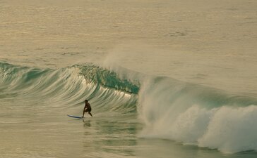 Surfer riding a wave at Amanera resort, Dominican Republic.