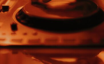 DJ turntable glowing in warm light at The Jazz Club, Aman New York.