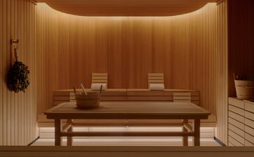 Spa treatment room at Aman New York with wooden bench seating and warm ambient lighting.