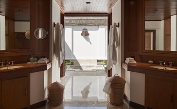 Duplex Pavilion bathroom at Amandari with dual vanities, marble flooring and view to garden.