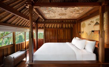 Principal bedroom in a duplex pavilion at Amandari, Indonesia, with four-poster bed and wooden beams.