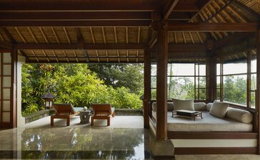 Duplex pavilion daybed at Amandari, with wooden interior opening to lush gardens and valley views.